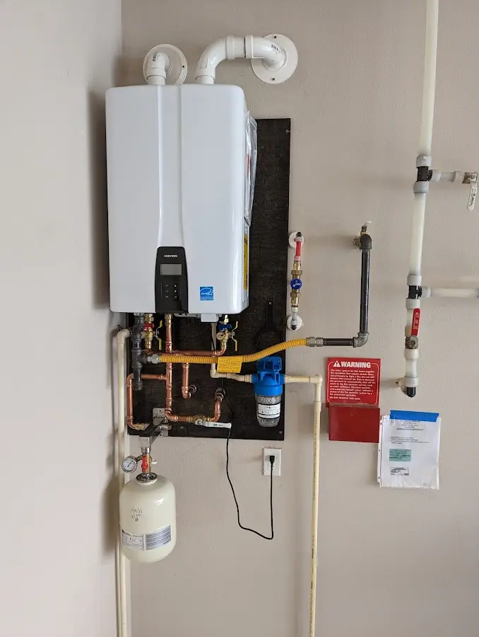 Professional plumber installing copper piping in a SeaTac home